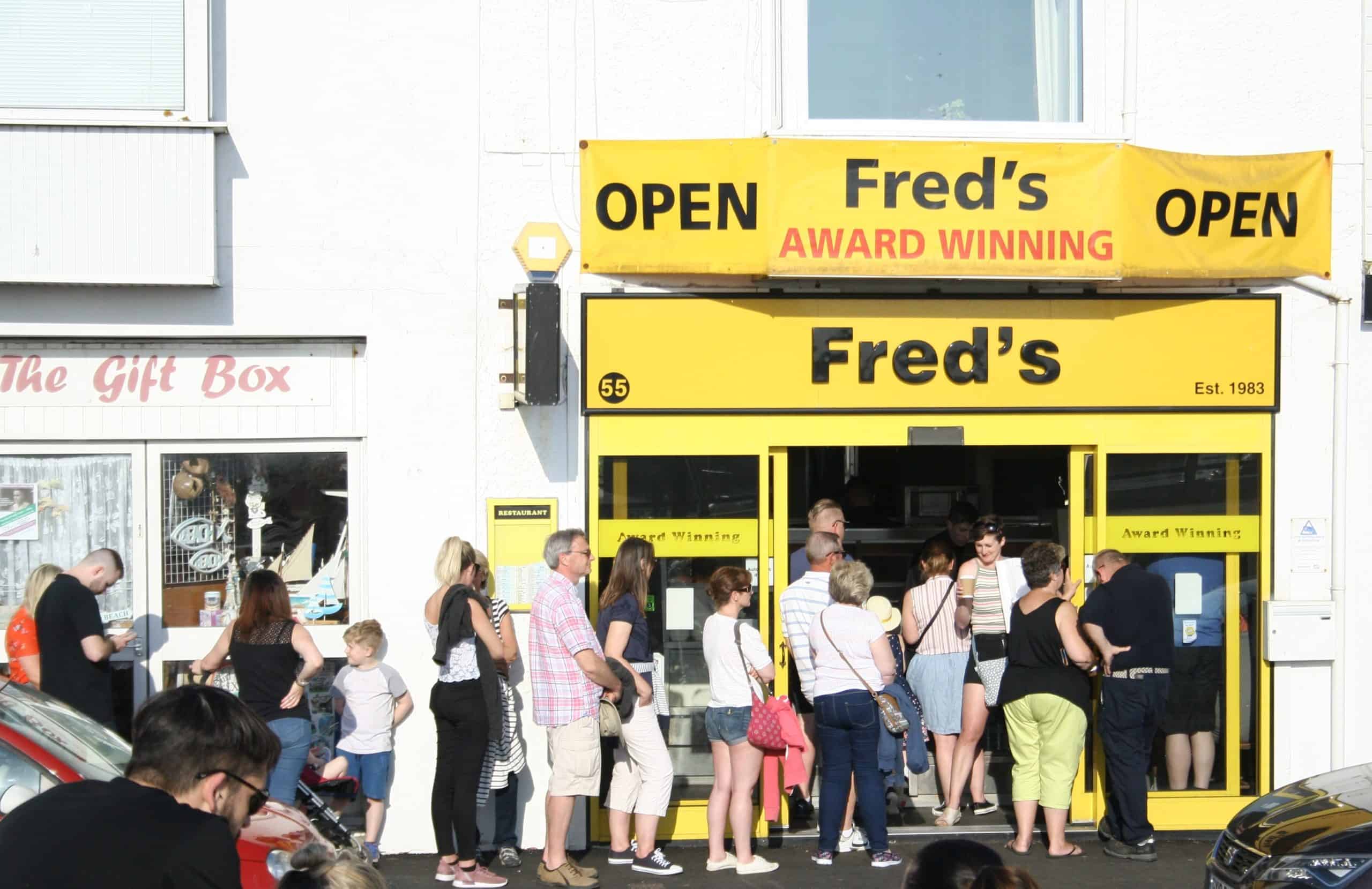  People queuing outside a store