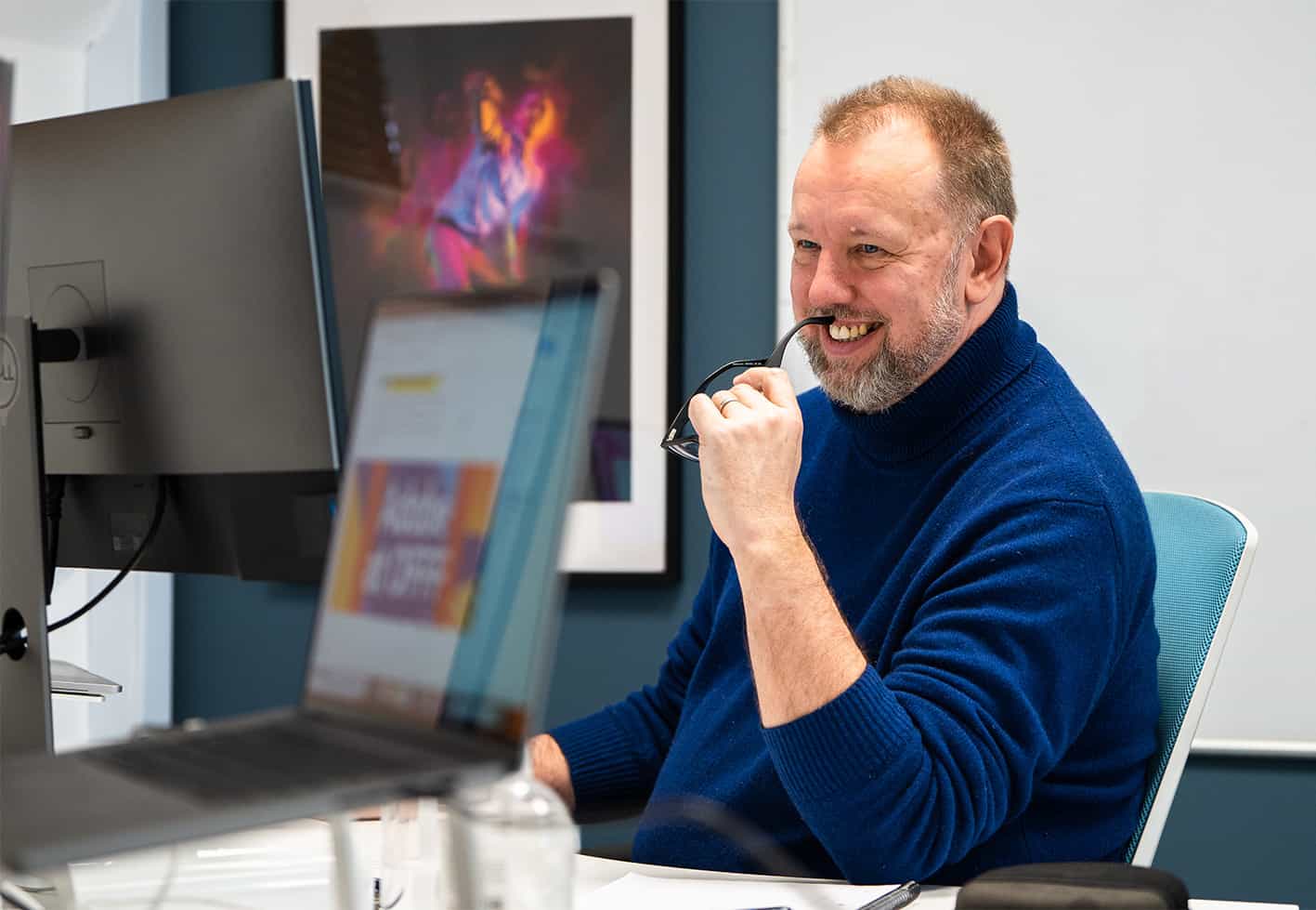 man sitting in front of a screen