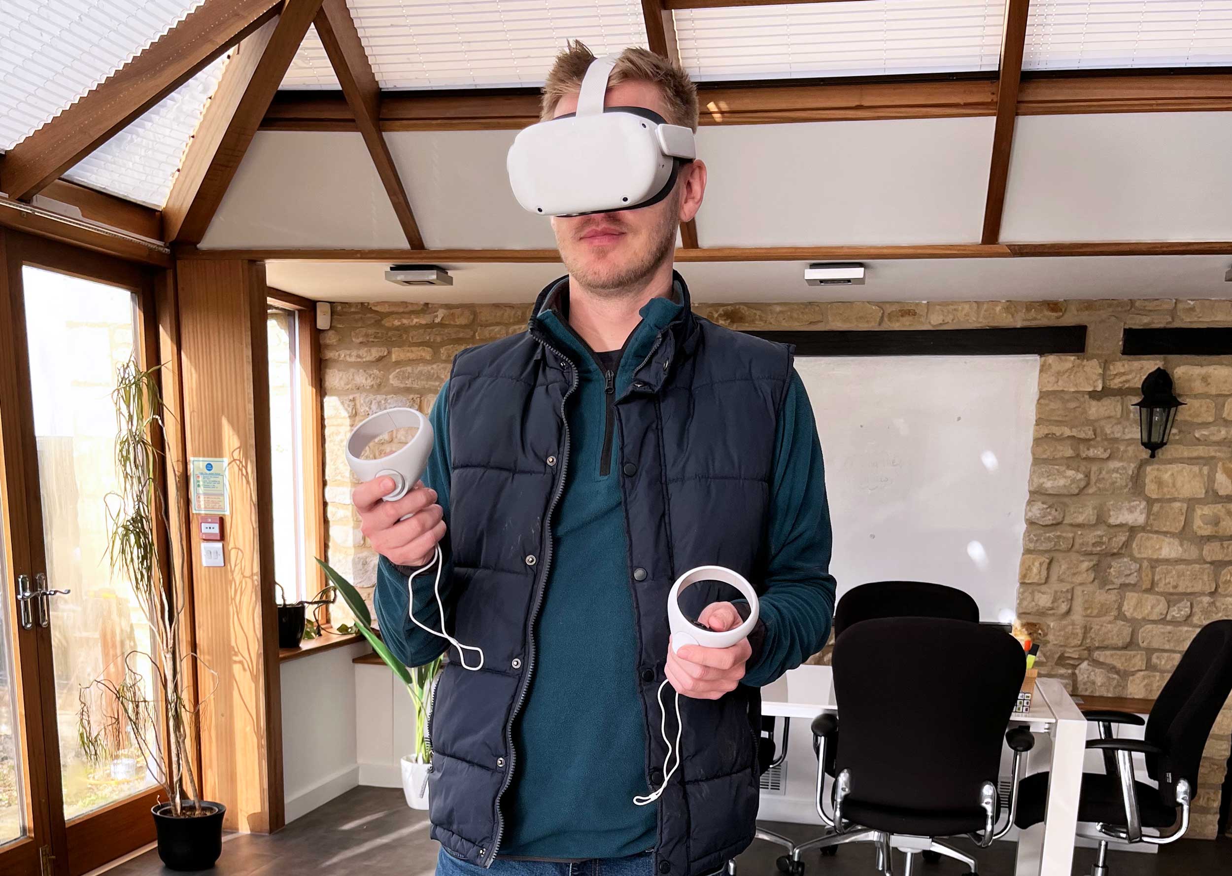 a UX designer with a VR headset on, working in Virtual Reality