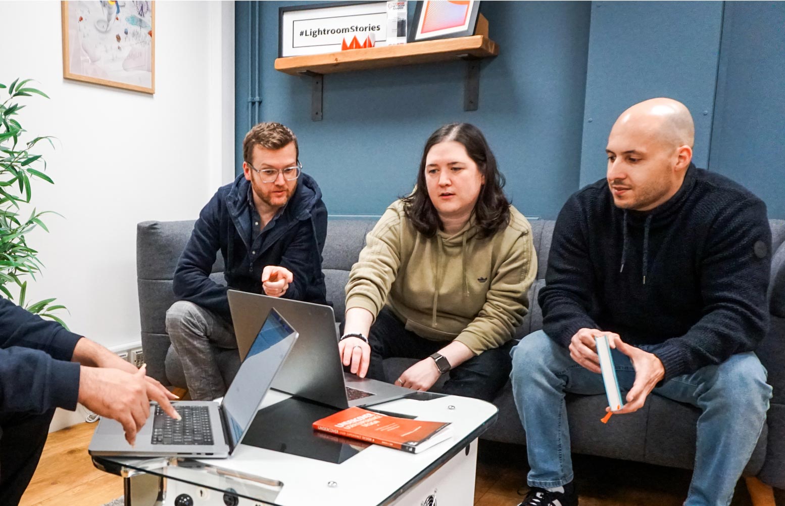 developers discussing a project in the lounge area of the office